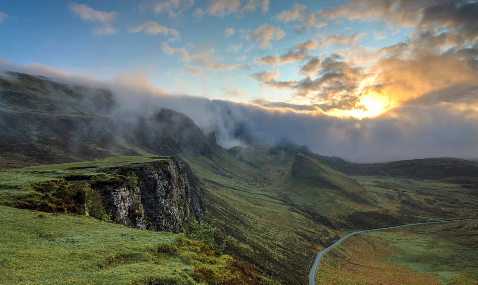Green cliffs above the Atlantic, morning mist